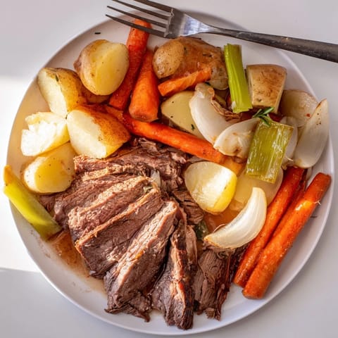 Aromatic Sunday Pot Roast with garlic and thyme, served with hearty seasonal vegetables.  