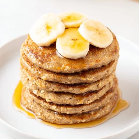 Warm and fluffy banana oat pancakes, perfect for a quick and healthy American breakfast.