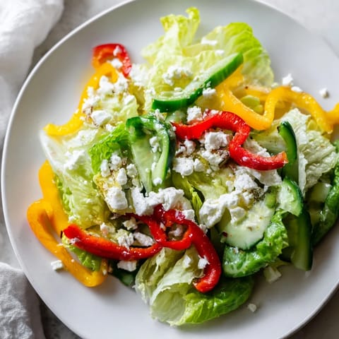 Bright, crisp Bella Hadid Salad, ready to eat, with crunchy lettuce and crumbled feta cheese.
