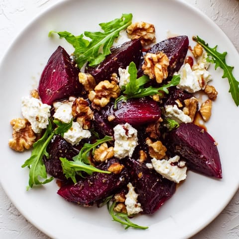 Freshly toasted walnuts add crunch to this vibrant Roasted Beet Goat Cheese Salad, drizzled with tangy balsamic.  