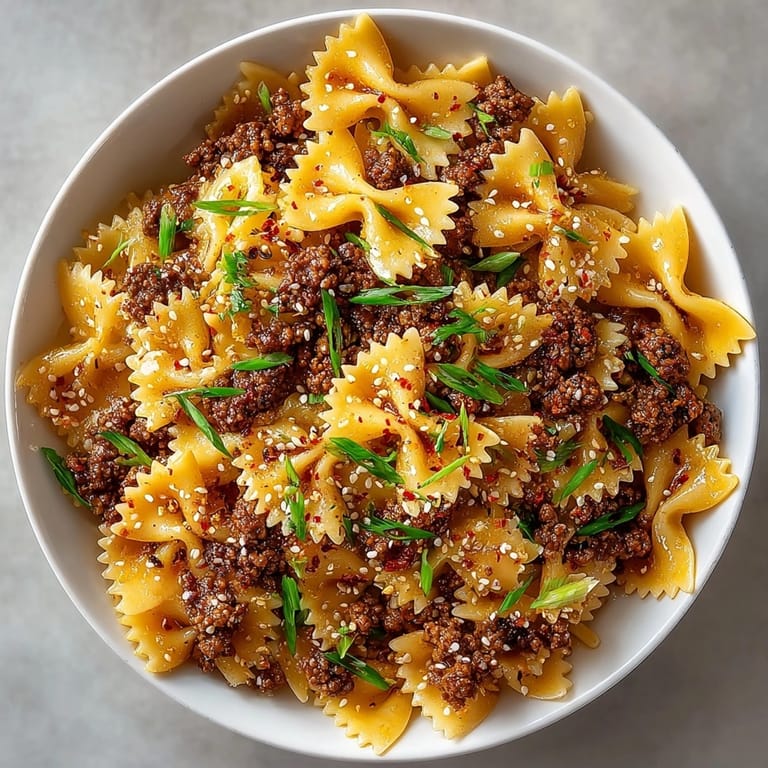 Fusion Korean BBQ Beef Bowtie Pasta mingled with glossy beef and farfalle, ready for dinner.