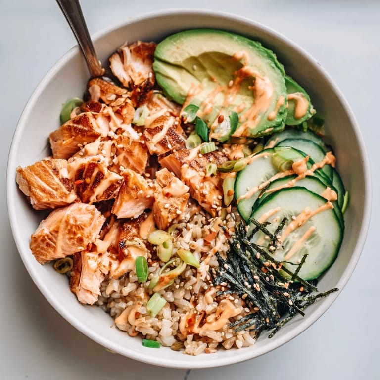 Enjoy a vibrant crispy salmon rice bowl, featuring fluffy rice and spicy toppings.