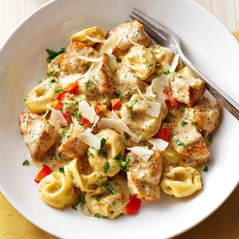 Delicious Zesty Cajun Garlic Parmesan Chicken Tortellini served with crusty bread for a perfect meal.