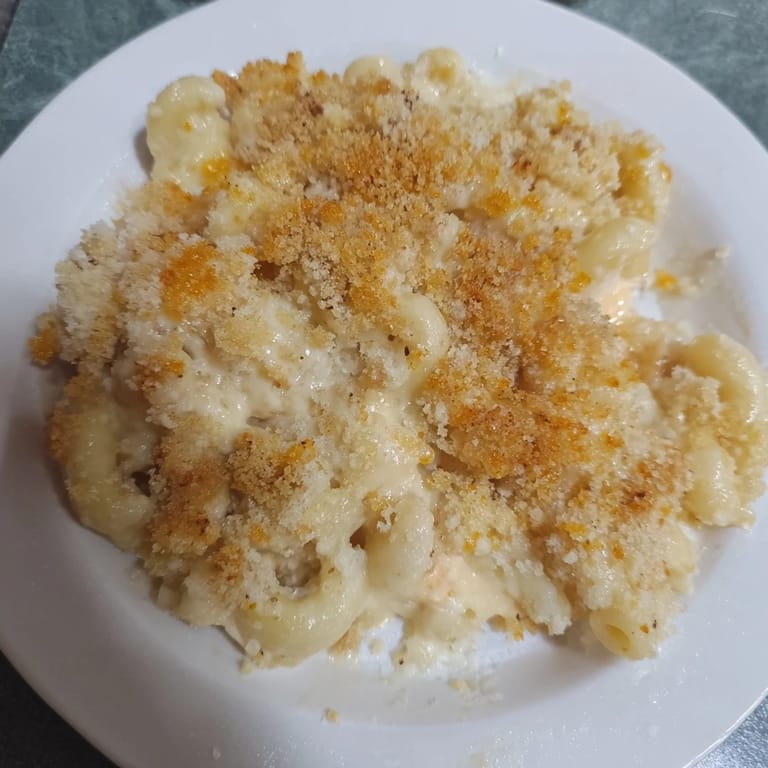 Warm, comforting bowl of Baked Macaroni and Cheese; perfect for a family dinner feast.