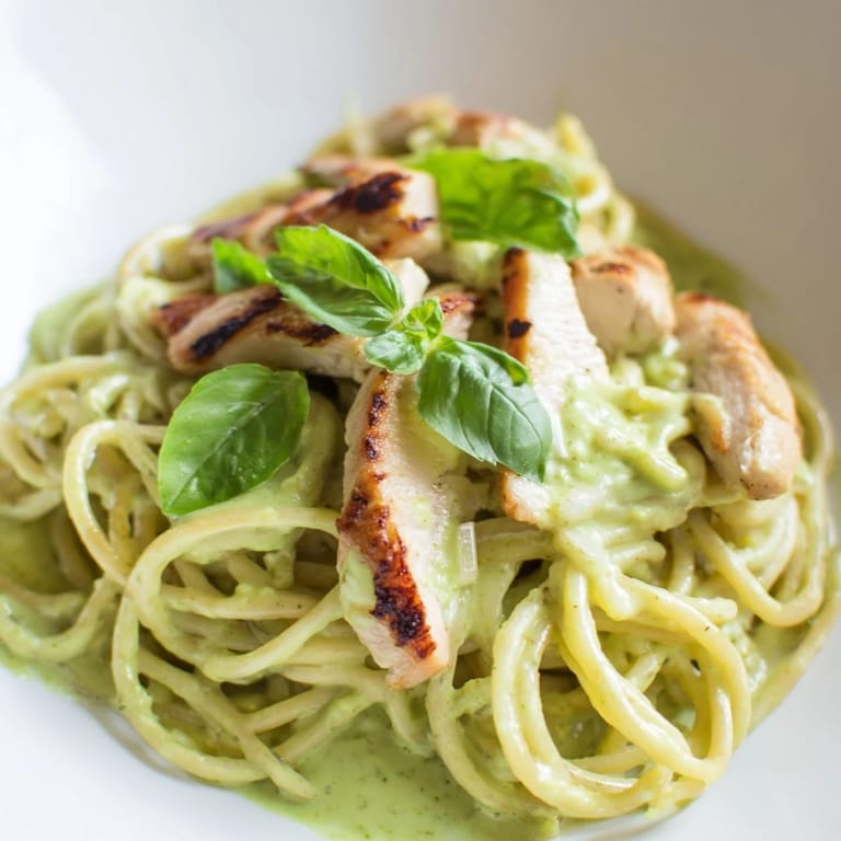 Creamy Avocado Chicken Pasta plated with creamy green sauce, lemon zest, and basil, ready for a quick, nourishing dinner.